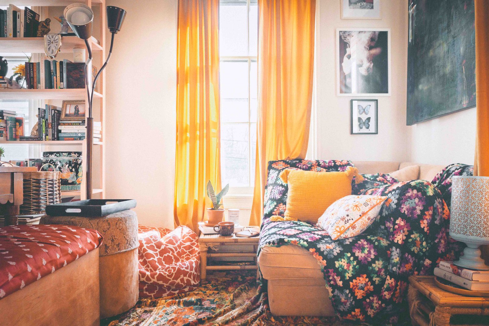 bohemian lifestyle living room with thrifted decor colorful textiles and warm light