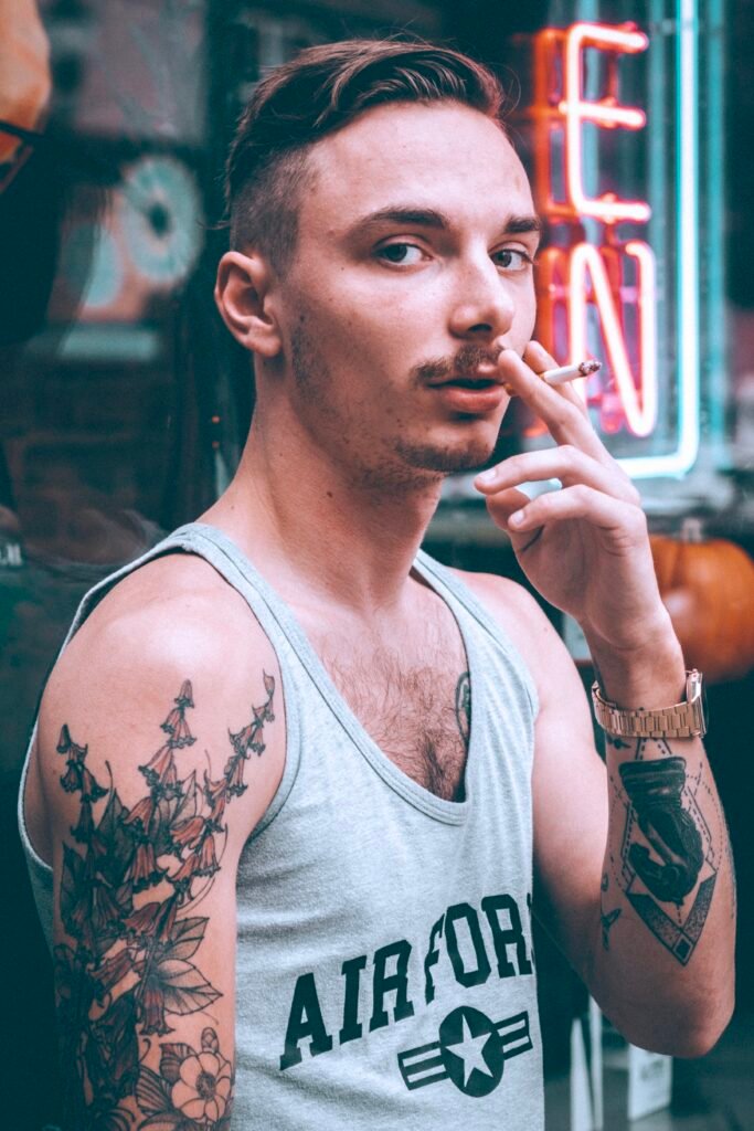 bohemian lifestyle street portrait of man with tattoos in urban setting
