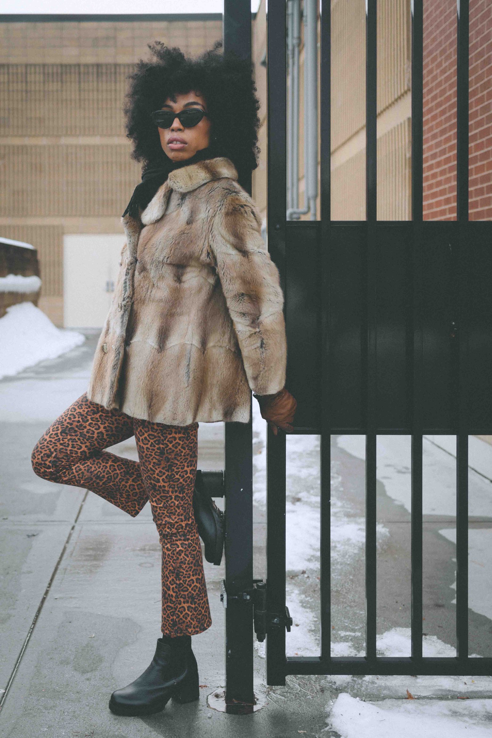 bohemian lifestyle street style outfit with vintage fur coat and leopard print pants