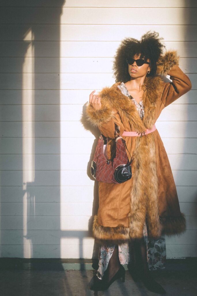 bohemian lifestyle fashion look with vintage coat styled in soft golden light