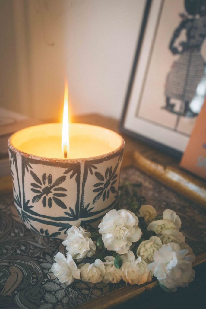cozy bohemian lifestyle home decor with candle flowers and warm ambient lighting