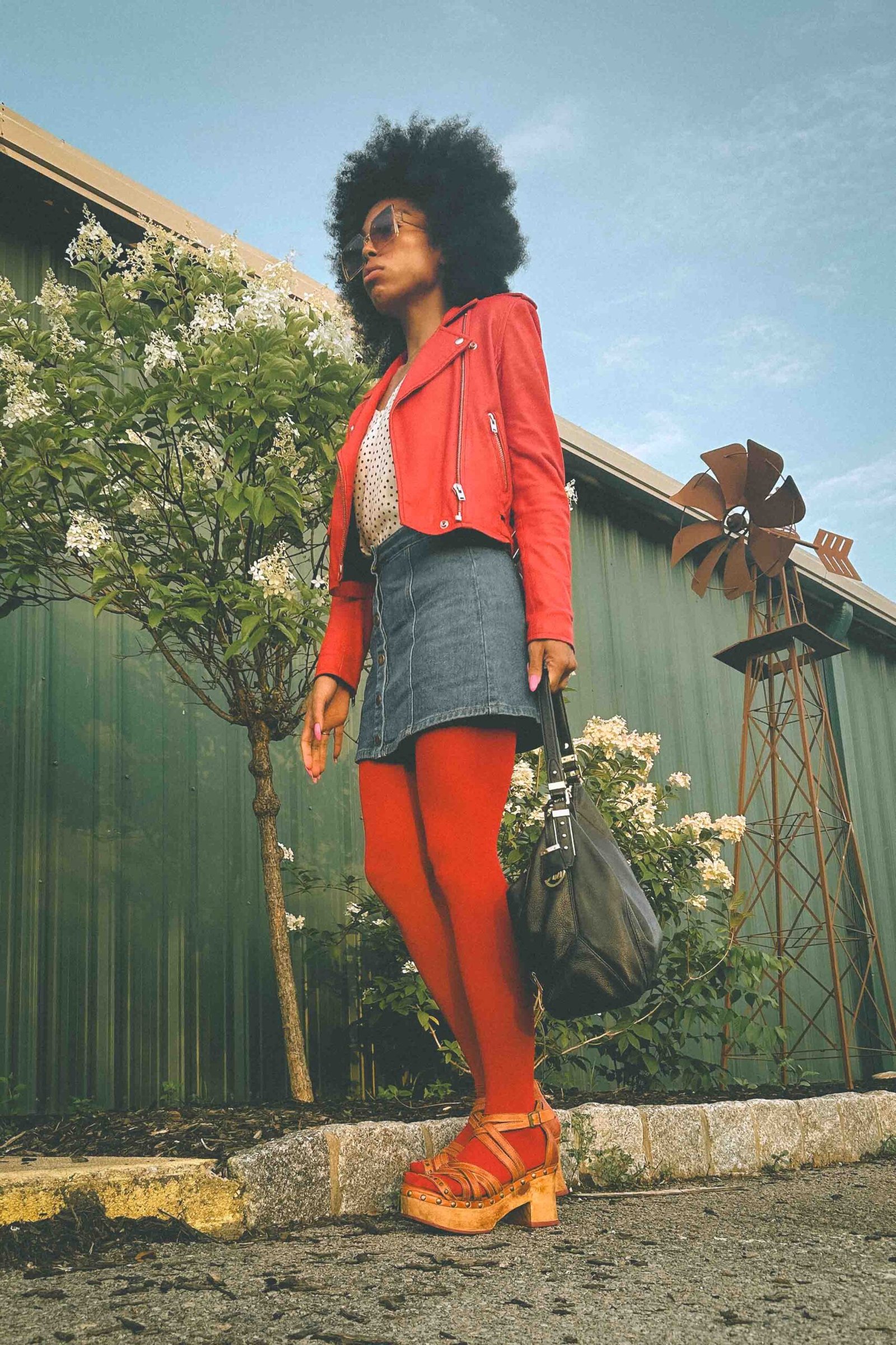 80s-inspired Inside My Closet outfit featuring a red leather moto jacket, denim mini skirt, and red tights, perfect for making a bold fashion statement.