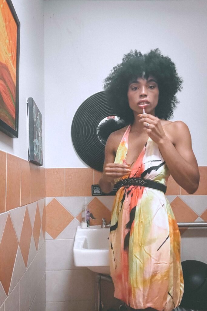 Final lipstick touch-up in the bathroom before walking into my debut New York art show in a thrifted halter dress.