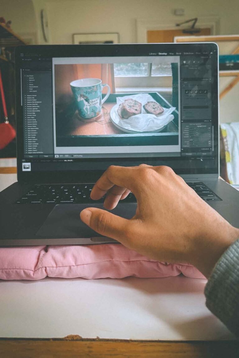 Editing cozy lifestyle photos in Lightroom on a laptop — part of a creative rebuild process for The Bohemian Bungalow blog.