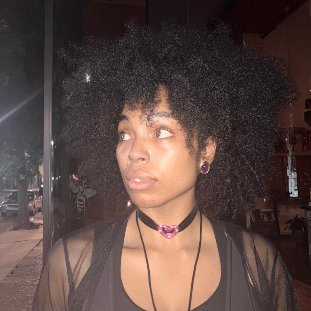 Creative night portrait of a woman wearing a heart choker — expressive brand imagery representing The Bohemian Bungalow’s digital sanctuary aesthetic.