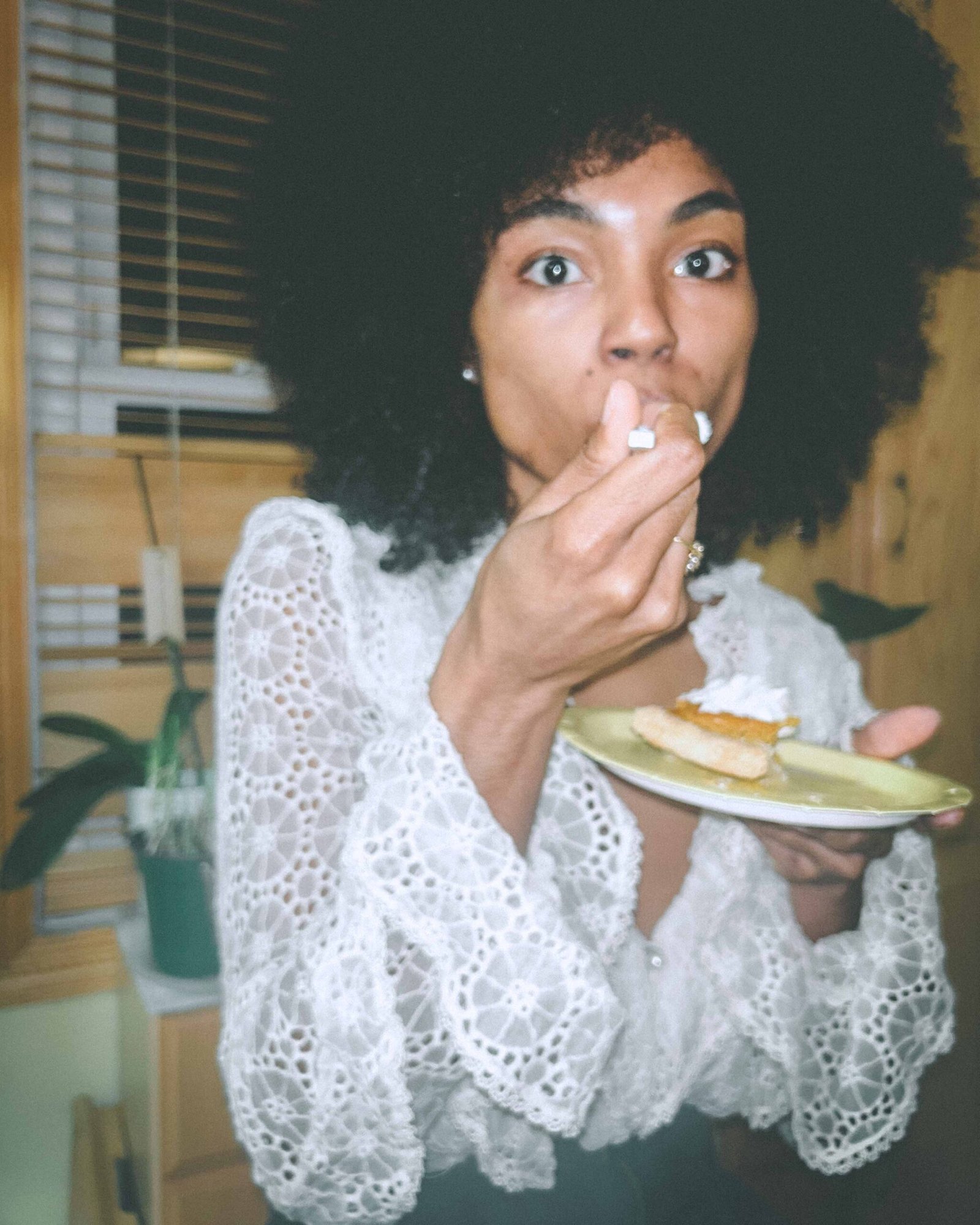 A candid flash photo of a woman in a lace blouse eating homemade sweet potato pie at Thanksgiving, capturing the raw emotion of feeling single during the holidays.
