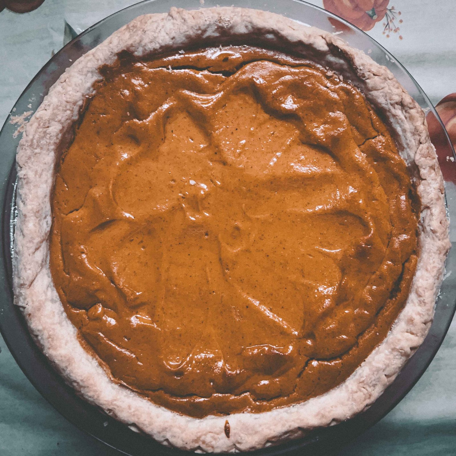 Homemade sweet potato pie with rustic crust photographed in soft vintage lighting for a Thanksgiving dessert story.