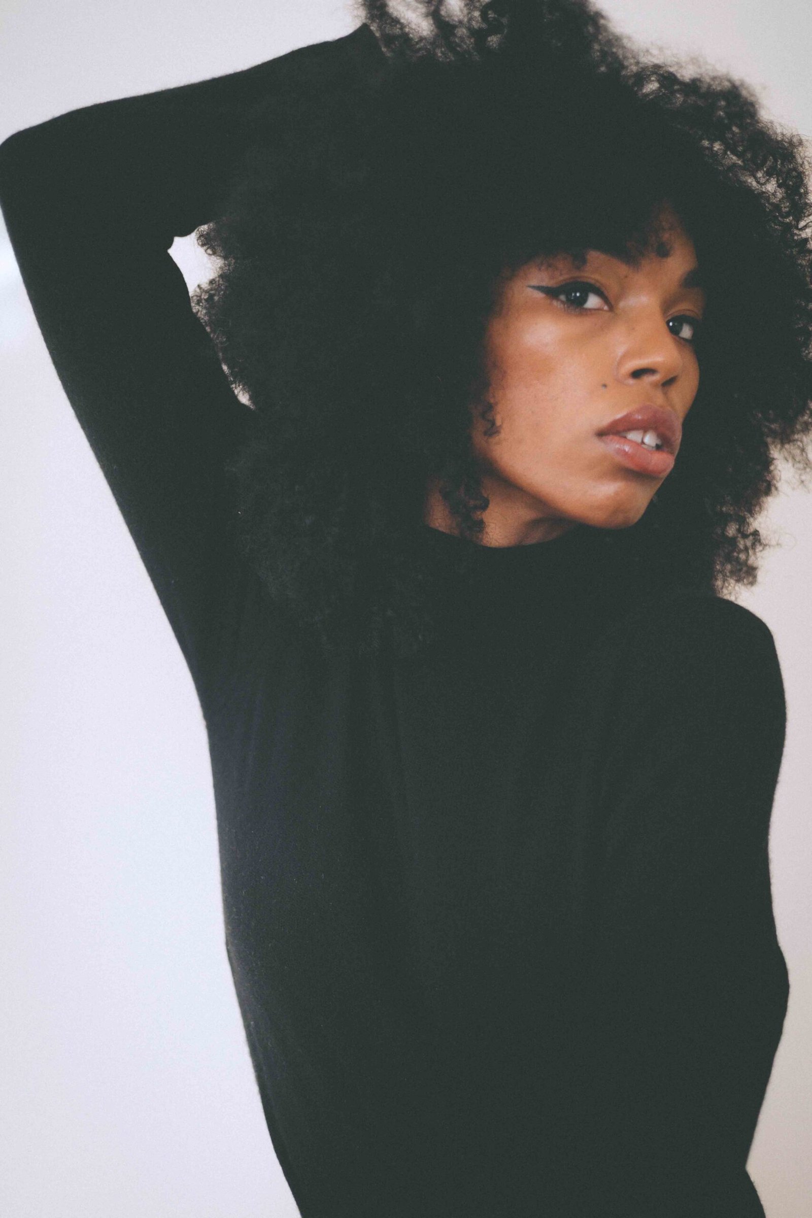 Close-up portrait of a black cashmere turtleneck sweater found inside my closet highlighting texture, neckline, and timeless winter styling