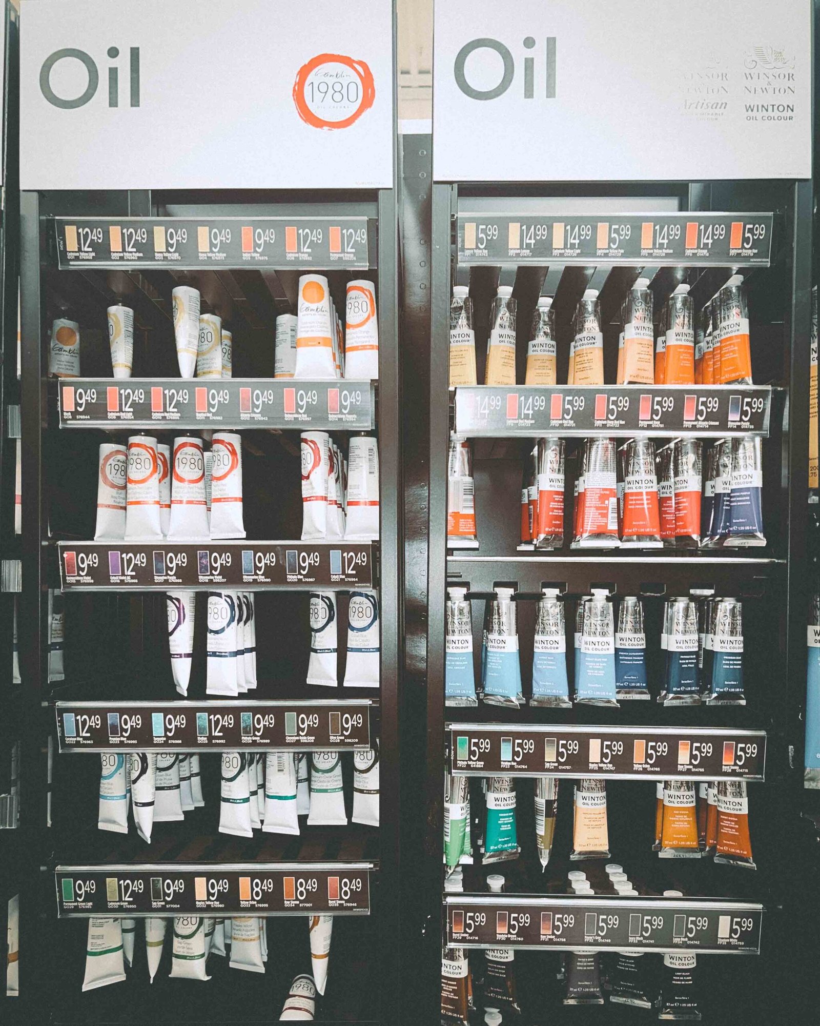 Art store shelf displaying Gamblin 1980 and Winsor & Newton Winton oil paints during a supply run for a new painting series.