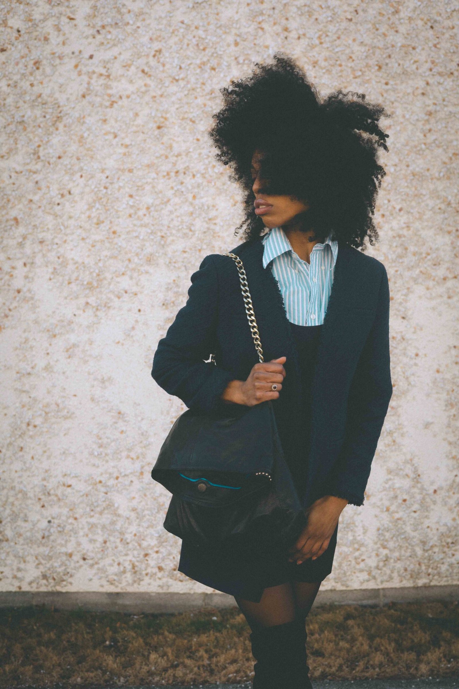 Art girl winter outfit featuring a thrifted tweed jacket, vintage chain bag, and layered dress worn during a quiet winter day in New York.