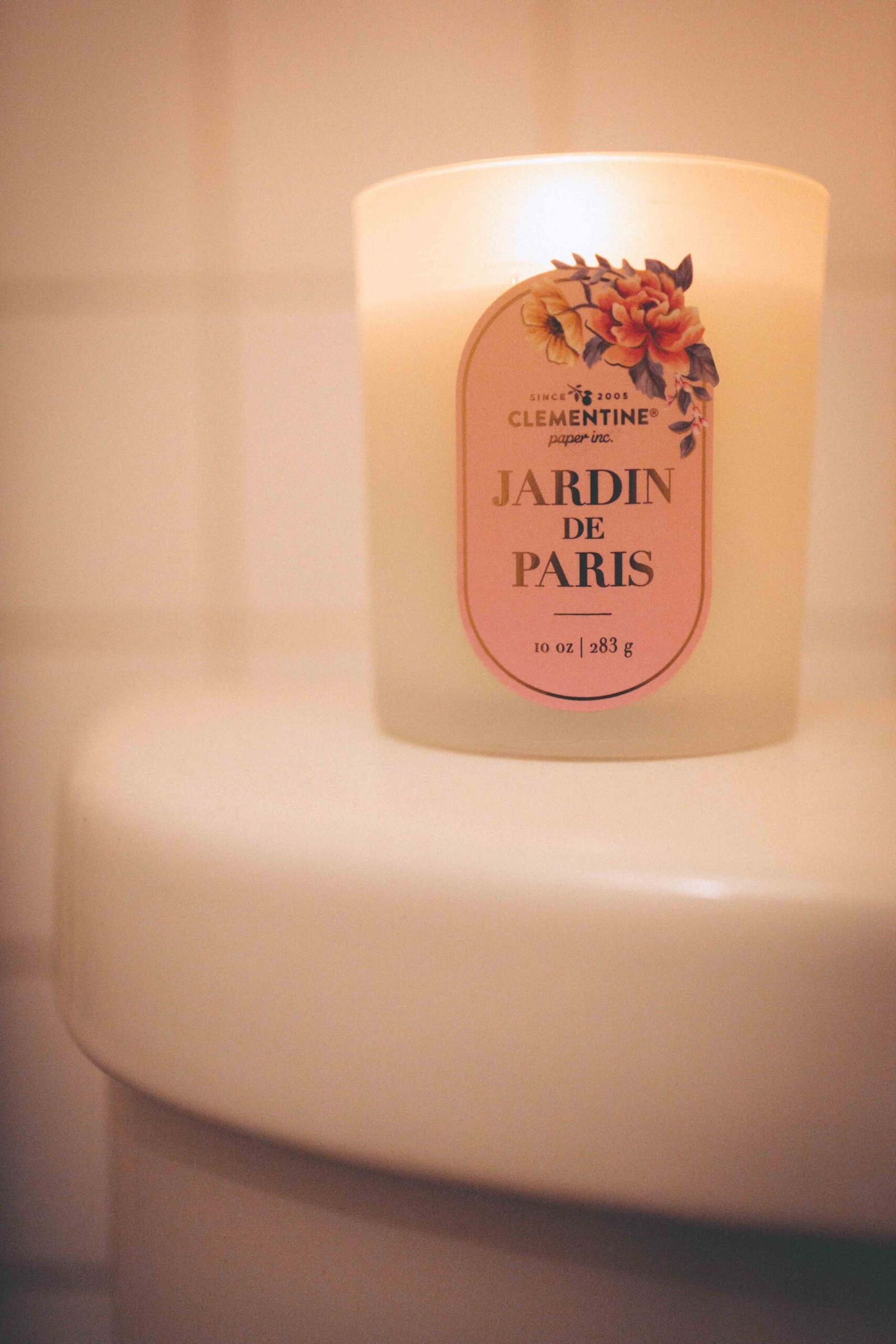Lit candle on a bathroom counter during an evening self-care ritual at home.