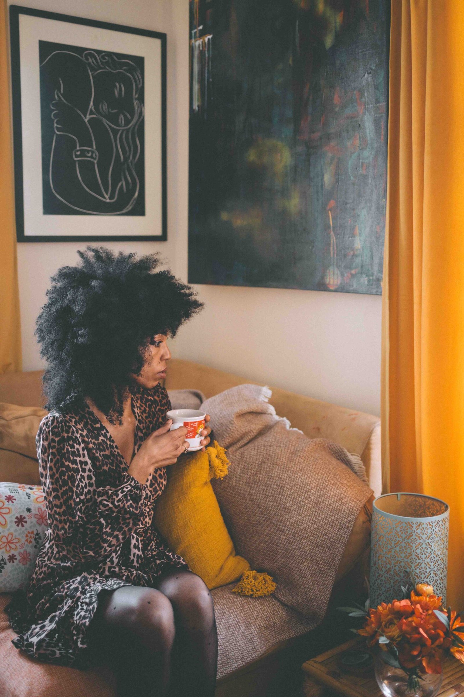 Self portrait at home holding a mug of coffee, embracing creative living and quiet morning rituals.
