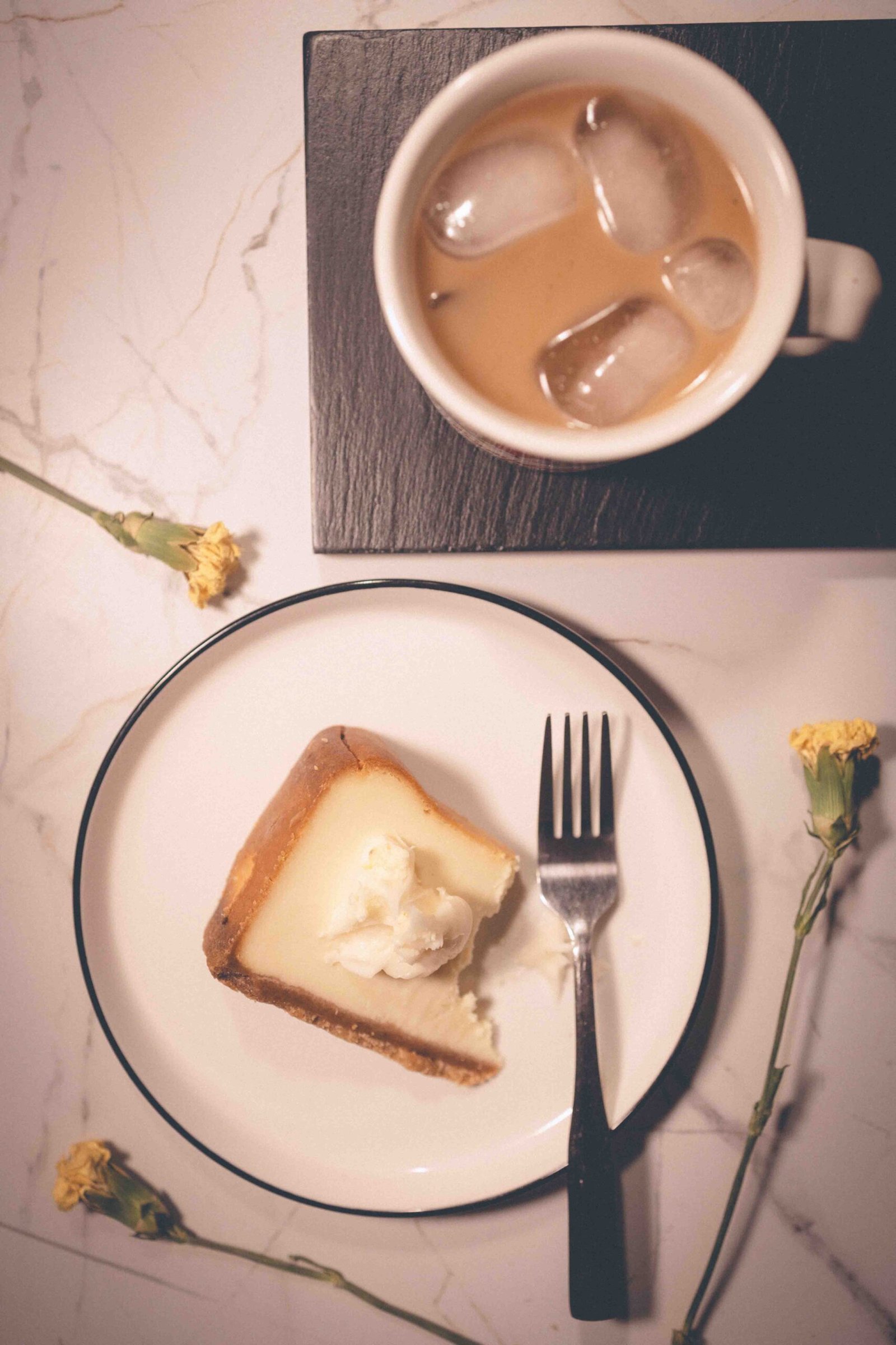 Slice of cheesecake and iced coffee, a small dessert ritual that makes everyday life feel more beautiful.