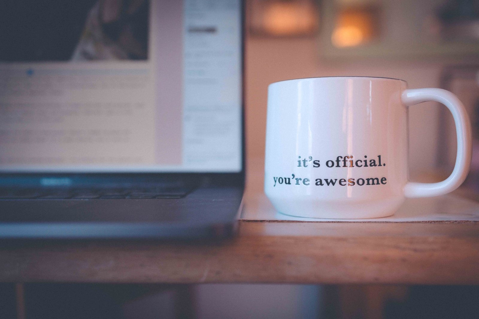A favorite coffee mug beside a laptop during a quiet morning routine at home.