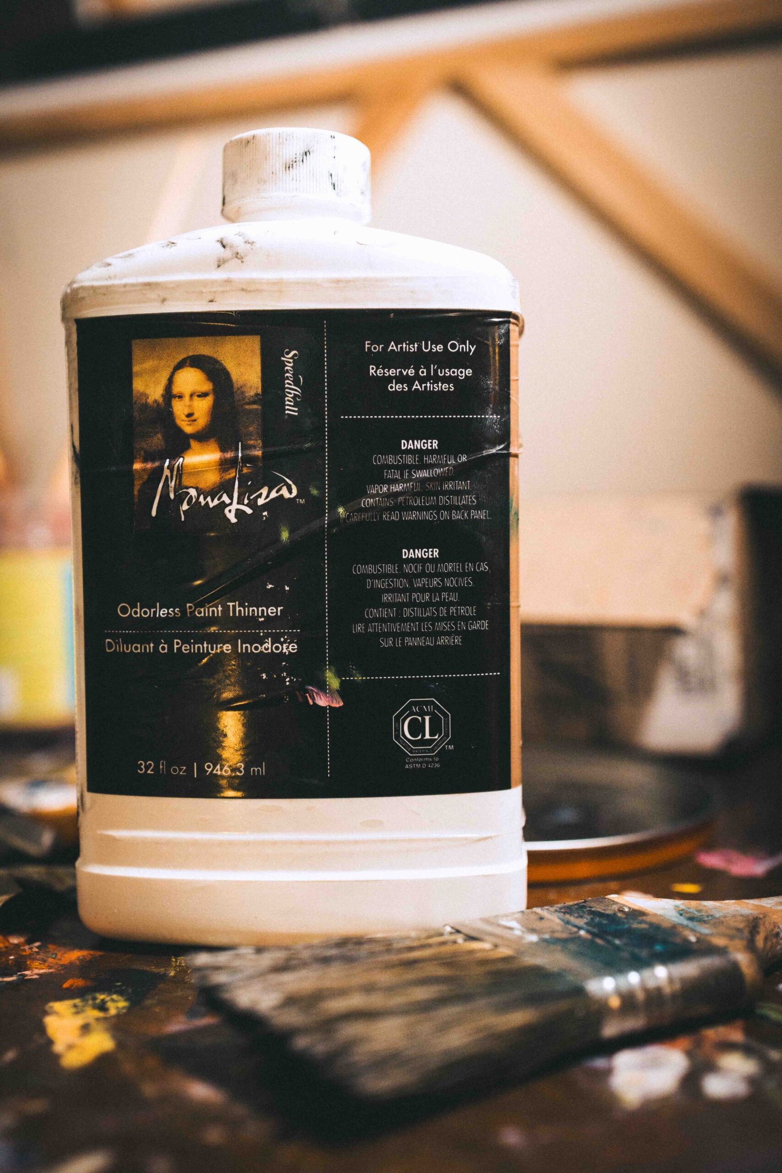 Oil paint thinner and brush in artist studio, part of the painting as therapy process involving physical materials and experimentation.