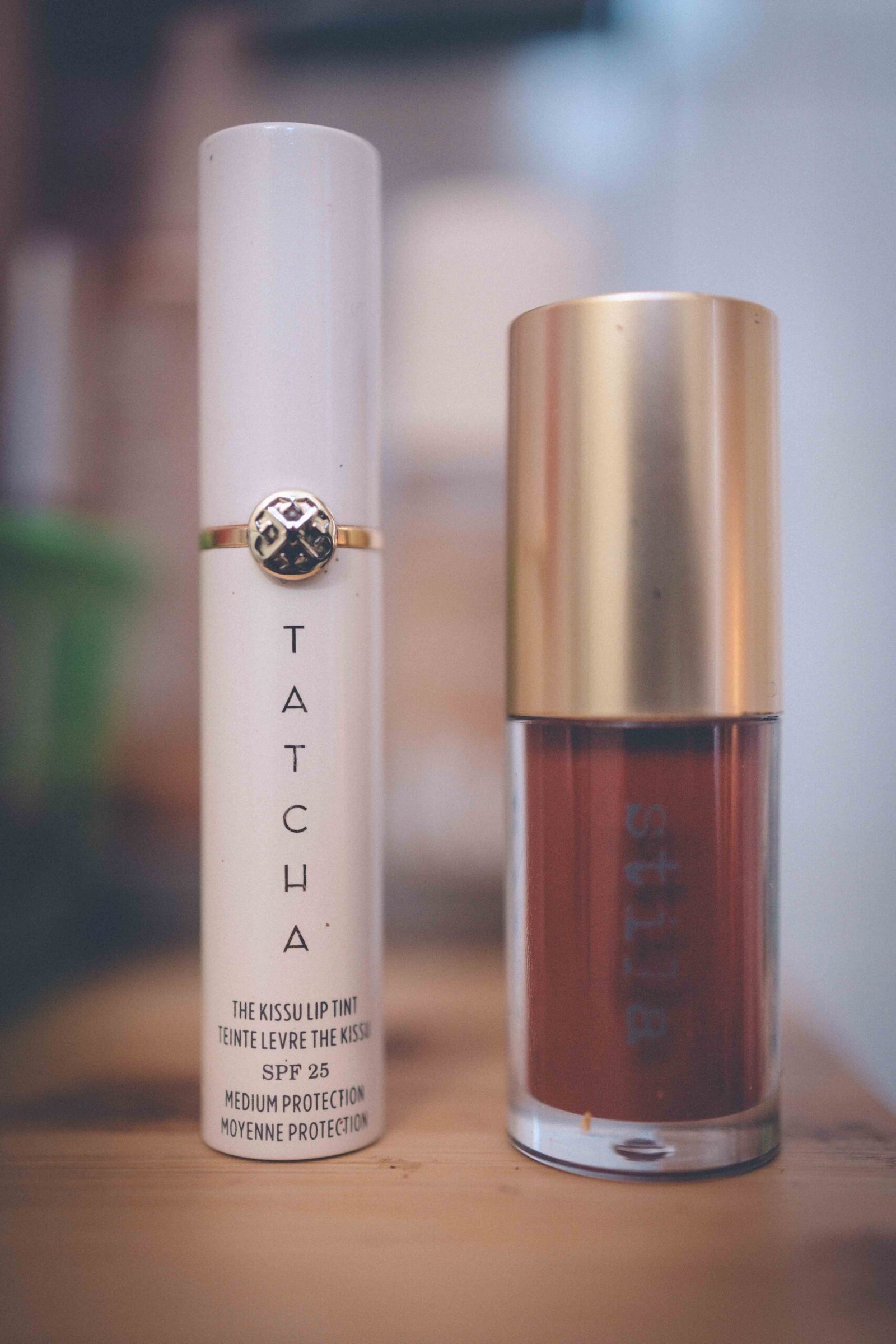 Lip tint and gloss used as part of a simple pre-gym beauty ritual, photographed as an everyday little luxury.