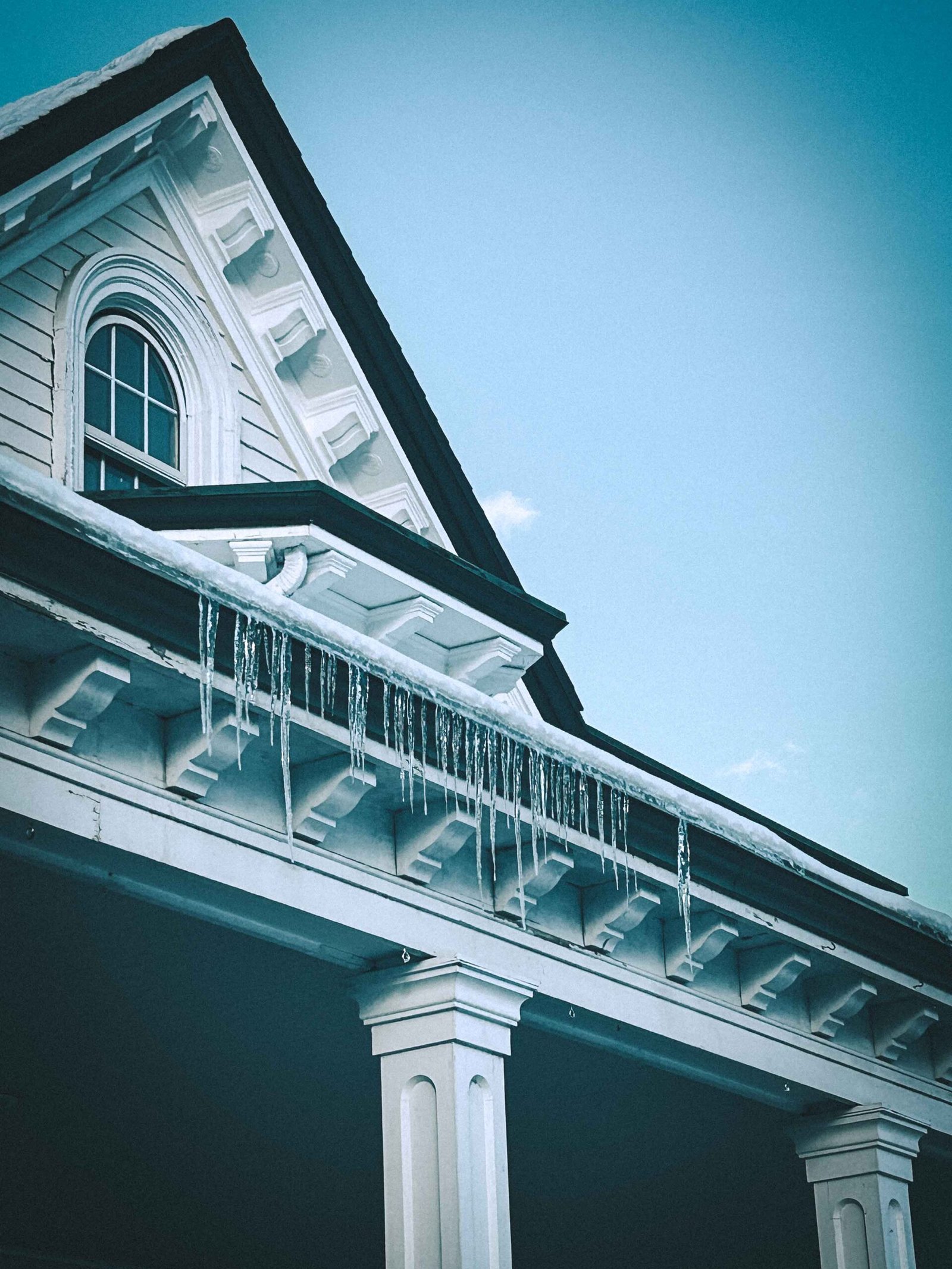 Quiet winter scene of a Victorian home with icicles, reflecting emotional stillness and the seasonal atmosphere behind painting as therapy.
