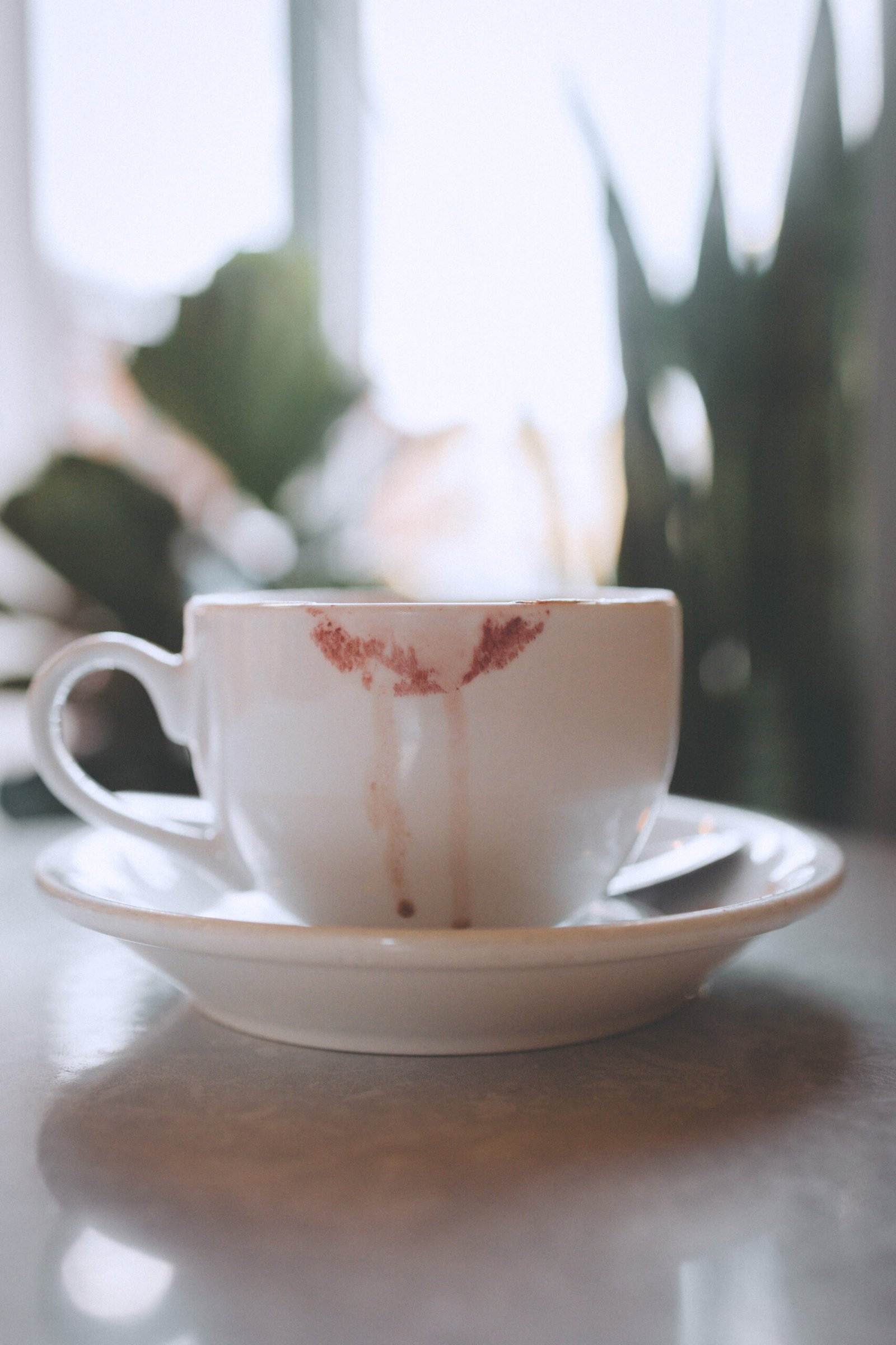 Close-up of a coffee cup with a lipstick mark, symbolizing quiet Valentine’s Day rituals and self-reflection.