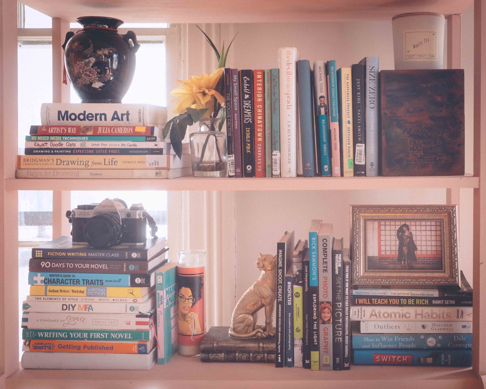 Styled bookshelf with books, vintage decor, and framed photo in a bohemian apartment