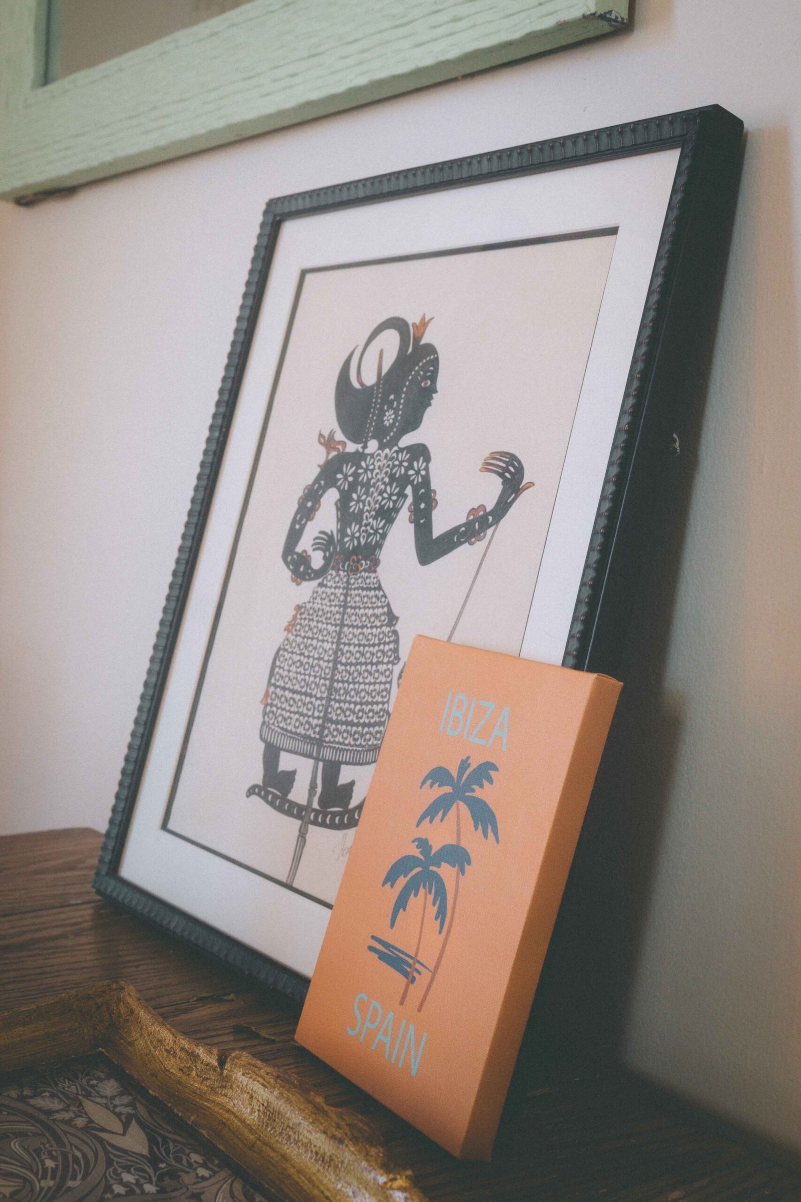 Bohemian apartment wall decor with framed art print and decorative travel print