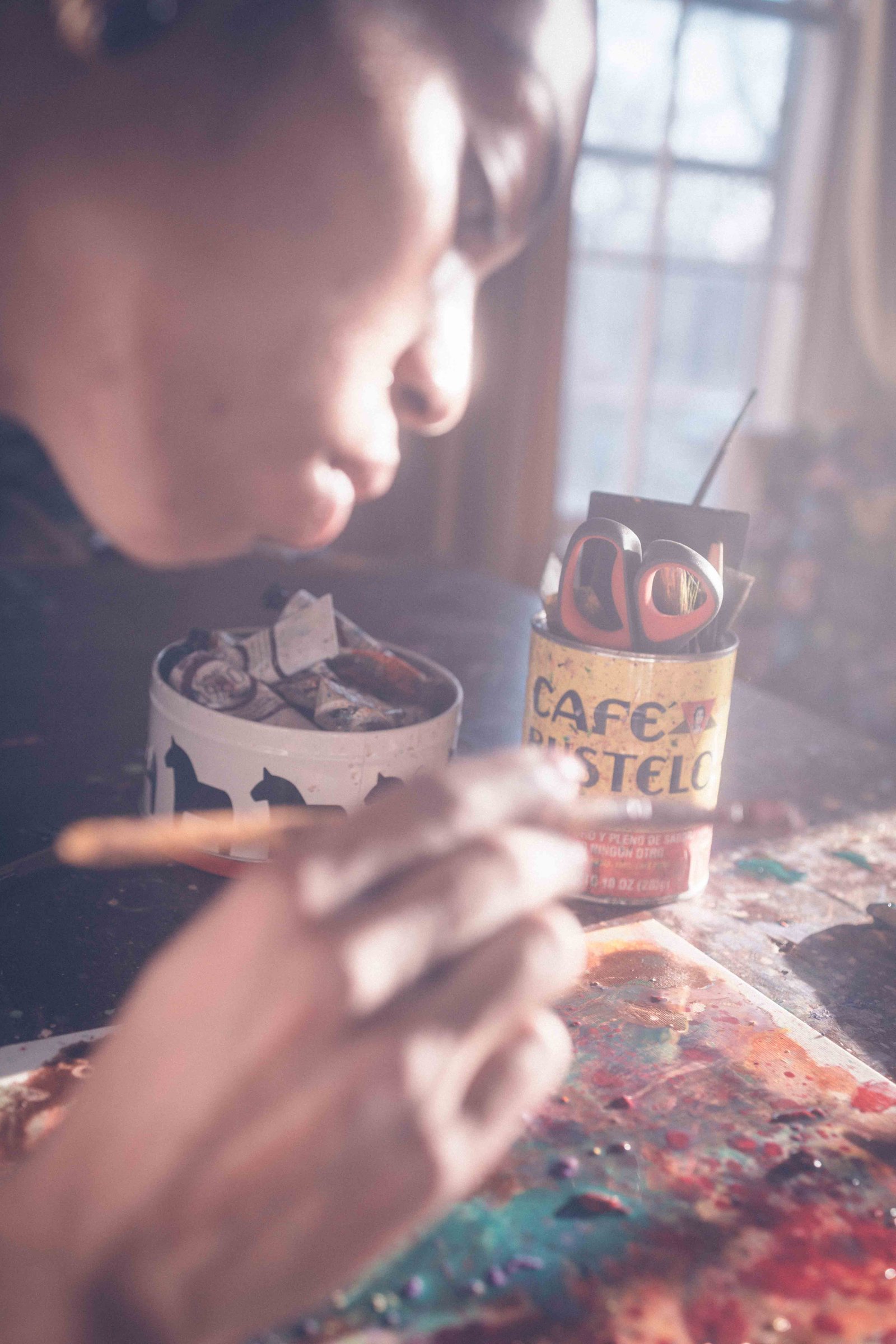 Artist painting in a home studio while learning how to get your creative spark back after burnout