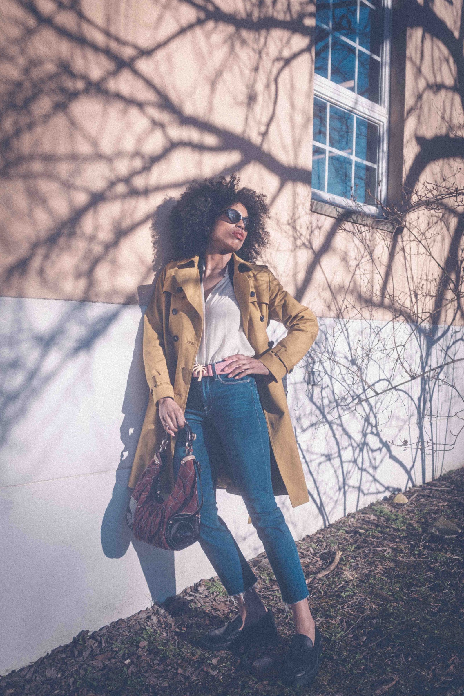 Black woman in vintage camel trench coat and jeans, full length editorial portrait, intentional personal style