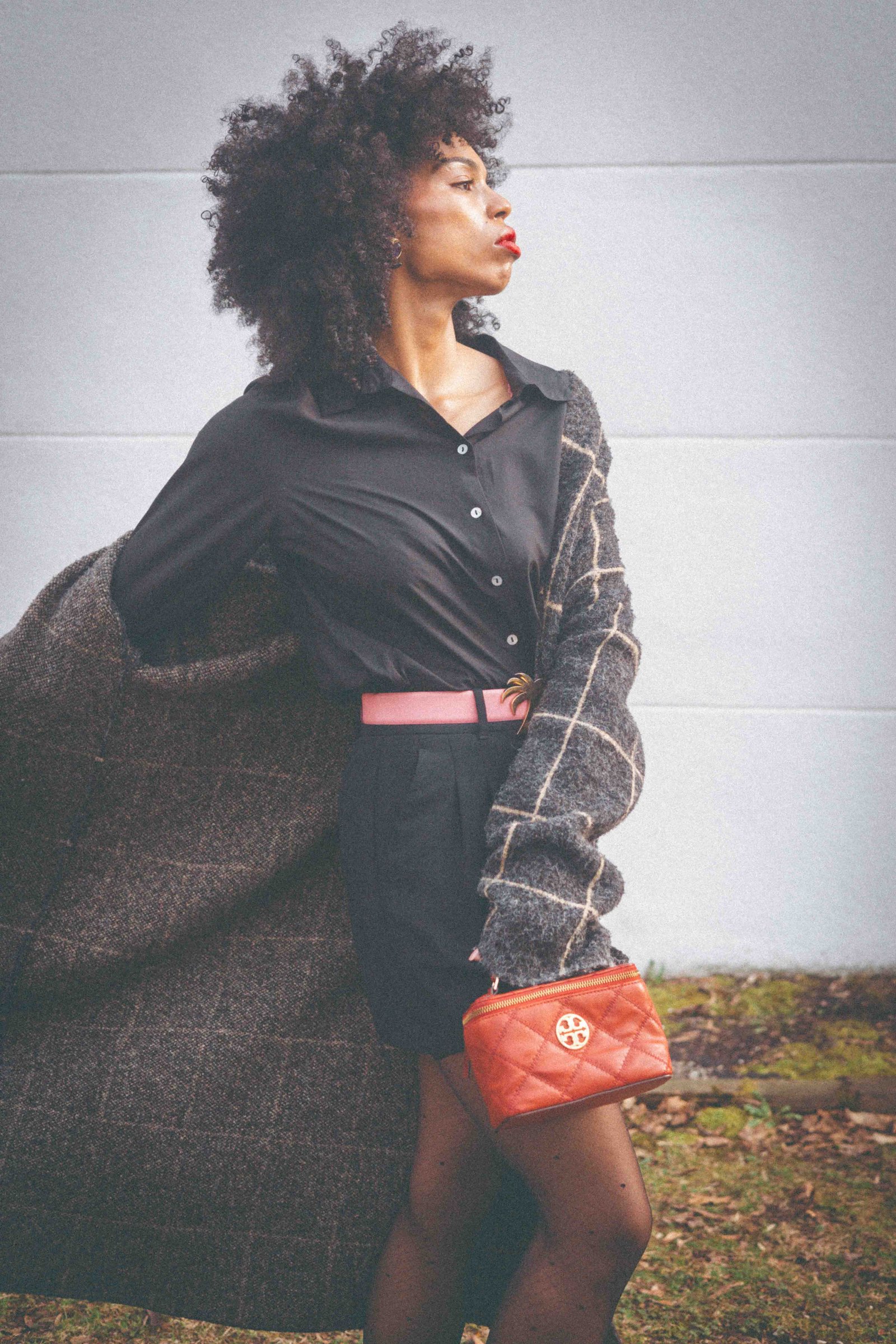 Black woman in oversized plaid cardigan and black shirt dress, side profile editorial portrait, dress like your dream self