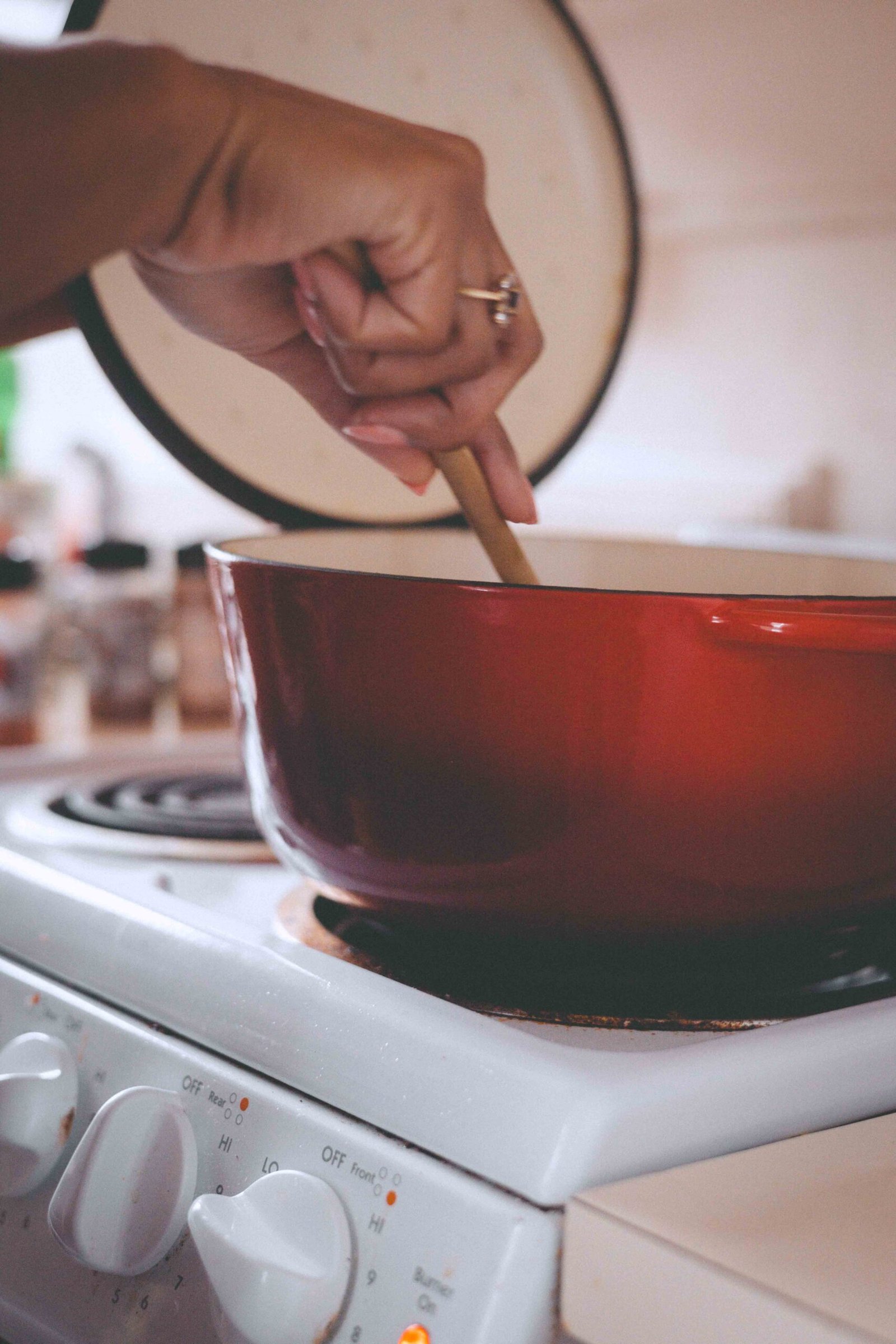 stirring a pot of homemade butternut squash soup on the stove as part of slow Sunday rituals