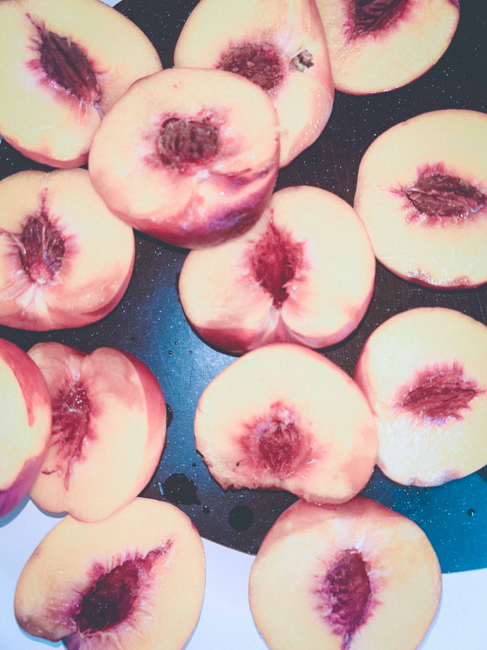 Fresh ripe peaches halved and ready to be sliced for peach cobbler.