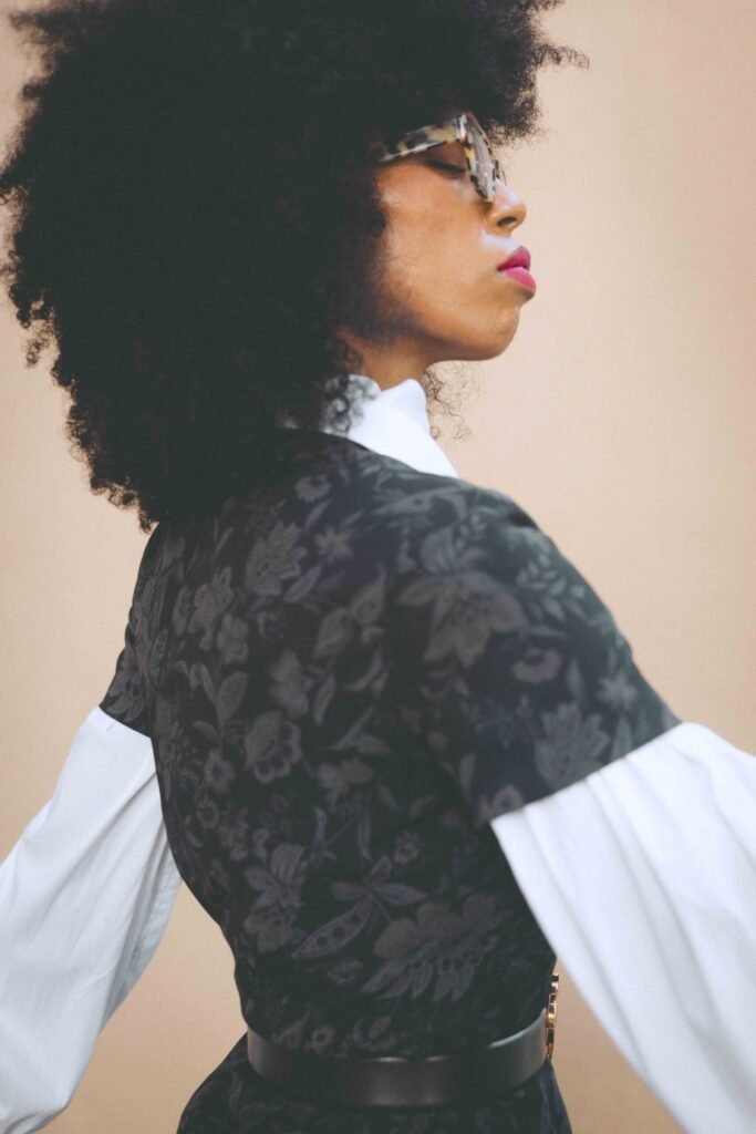 Side portrait showing the floral dress, white balloon sleeve and Palm Angels belt