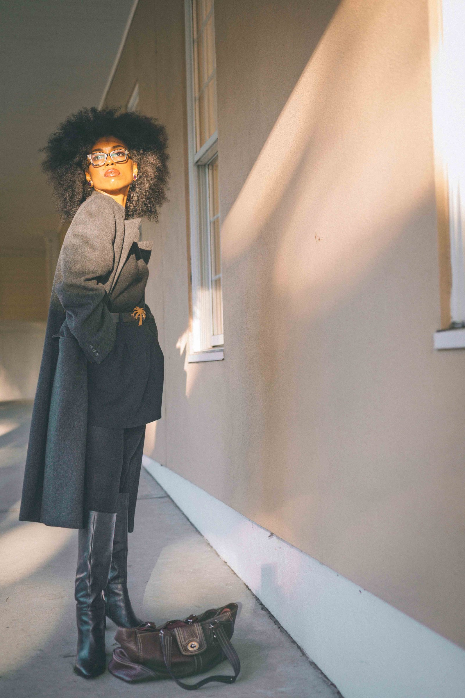 Full-length portrait of a monochrome black fall outfit with a charcoal wool coat