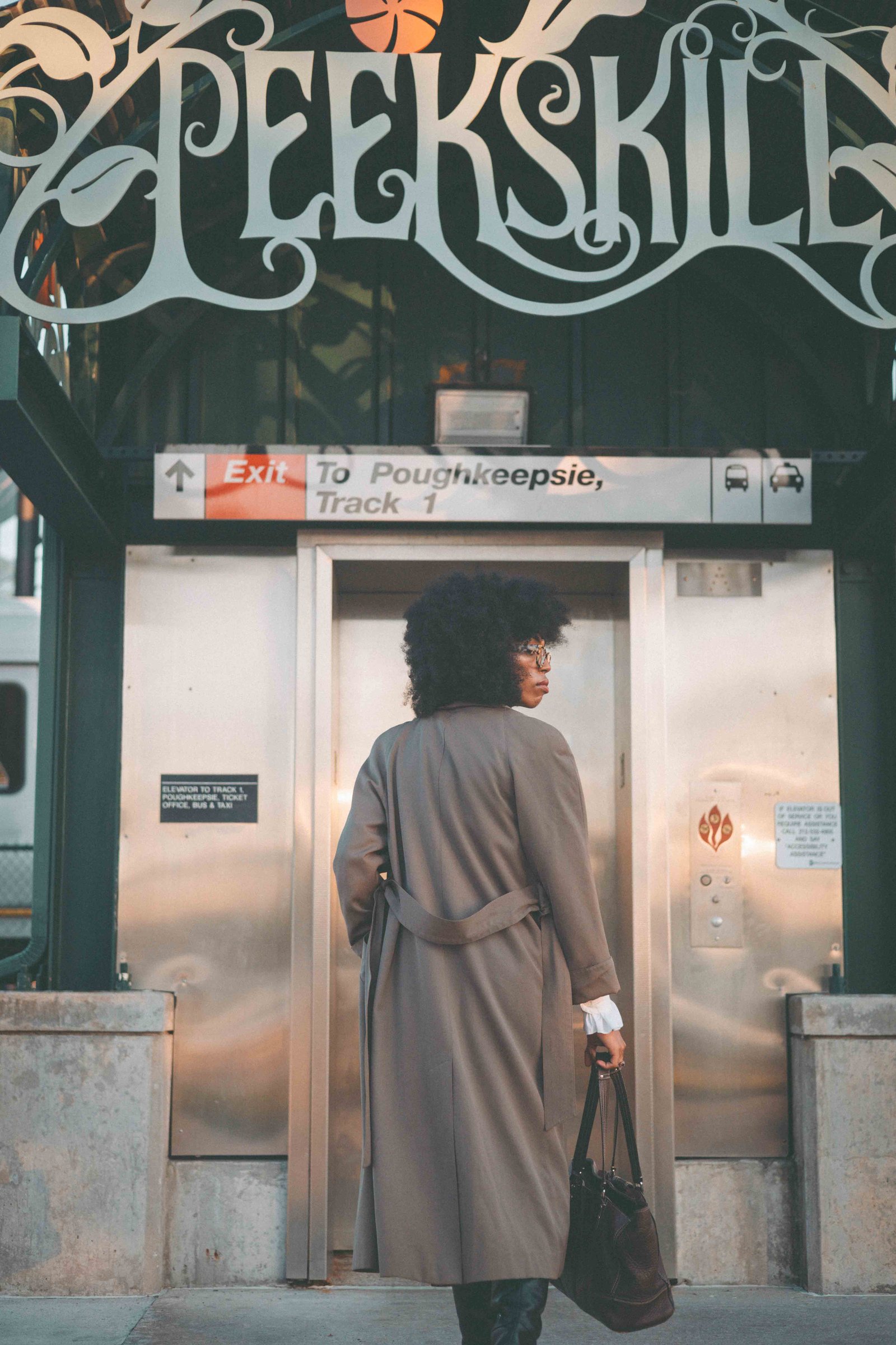 Back view of a vintage belted trench coat outside Peekskill station