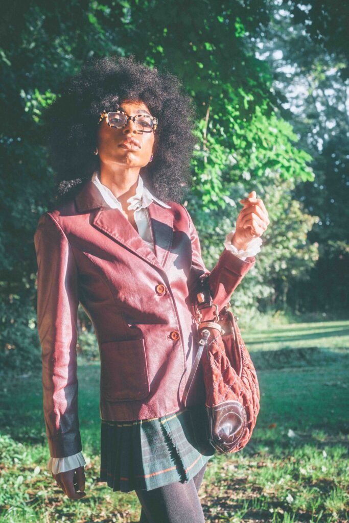 Portrait of a woman carrying a vintage Juicy Couture bag with a burgundy leather blazer